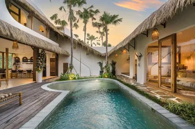 a pool in the backyard of a house with palm trees at Villa Casa Eldorado by BaliSuperHost in Kerobokan