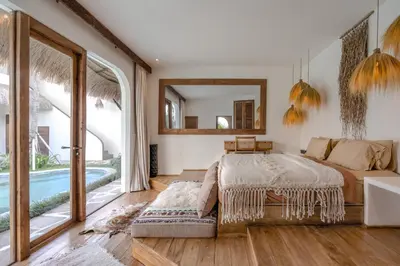 a bedroom with a bed and a large window at Villa Casa Eldorado by BaliSuperHost in Kerobokan