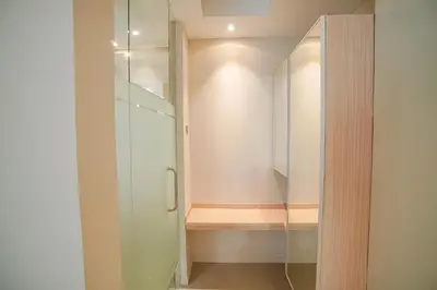 a walk in closet with a glass door at Bustle Base Coliving and Coworking Space in Legian