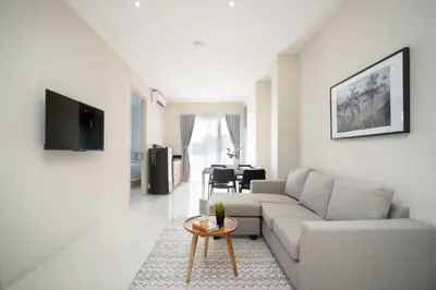 a living room with a couch and a table at Bustle Base Coliving and Coworking Space in Legian