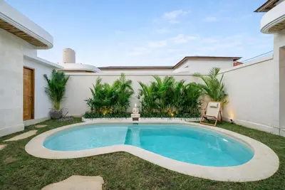 a swimming pool in the backyard of a house at Nooky 1 - 2BR Villa with HUGE Pool in Kerobokan