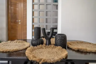 a table with two black utensils on a table at Nooky 1 - 2BR Villa with HUGE Pool in Kerobokan