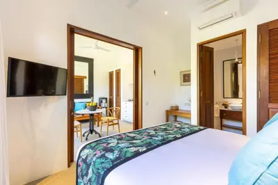 a bedroom with a bed with a television and a table at Paradise in the heart of Seminyak, 1-BR Pool-Villa in Seminyak