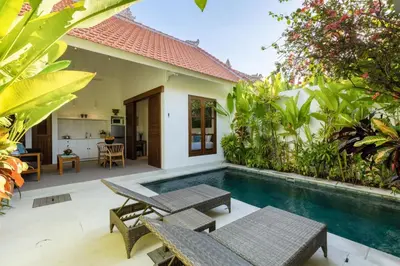 a backyard with a swimming pool and a house at Paradise in the heart of Seminyak, 1-BR Pool-Villa in Seminyak