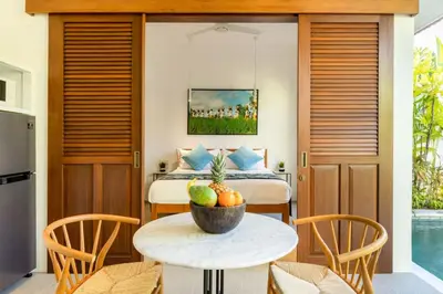 a bedroom with a bed and a table with a bowl of fruit at Paradise in the heart of Seminyak, 1-BR Pool-Villa in Seminyak