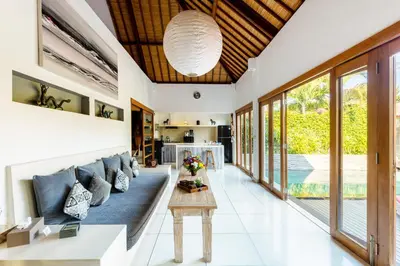 a living room with a blue couch and a table at 2 Bedroom Villa with Pool Seminyak with Car Park in Seminyak