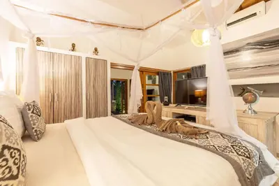 a bedroom with a bed with a canopy at 2 Bedroom Villa with Pool Seminyak with Car Park in Seminyak