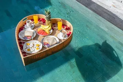 a table with food in a boat in the water at 2 Bedroom Villa with Pool Seminyak with Car Park in Seminyak