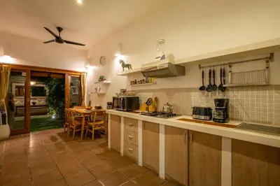 a kitchen with a counter and a table in it at Cozy 2 Bedroom Villa in Seminyak with private Pool in Seminyak