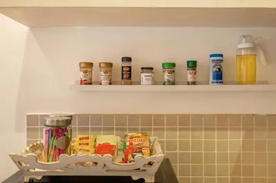 a shelf in a kitchen with food items on it at Cozy 2 Bedroom Villa in Seminyak with private Pool in Seminyak