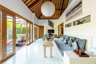 a living room with a couch and a table at Luxurious and Cozy King Beds, Pool, closed living room in Kuta