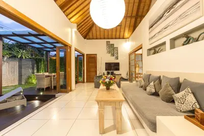 a living room with a couch and a table at Luxurious and Cozy King Beds, Pool, closed living room in Kuta