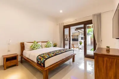 a bedroom with a large bed and a balcony at Seminyak lush tropical paradise close to Eatstreet in Seminyak