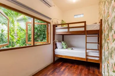 a bedroom with bunk beds and a window at Seminyak lush tropical paradise close to Eatstreet in Seminyak