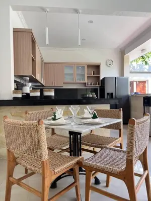 a kitchen with a table and chairs in a kitchen at Seminyak lush tropical paradise close to Eatstreet in Seminyak