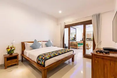a bedroom with a bed and a balcony at Seminyak lush tropical paradise close to Eatstreet in Seminyak