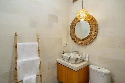 a bathroom with a sink and a mirror and a toilet at Nooky 2 - PROMO Seminyak - 2 BDR - Brand NEW Villa - HUGE Pool in Kerobokan