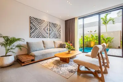 a living room with a couch and a table at Casa Tropicale Seminyak in Seminyak