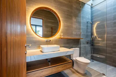 a bathroom with a sink and a mirror and a toilet at Casa Tropicale Seminyak in Seminyak