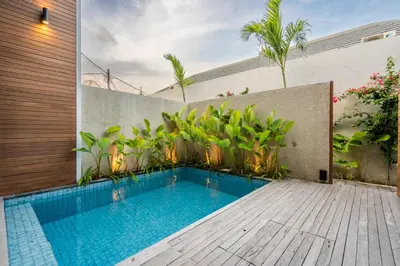 a swimming pool in the backyard of a house at Casa Tropicale Seminyak in Seminyak