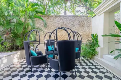 two chairs sitting on a checkered floor at 4BR Villa with Large Pool at Seminyak Beach in Seminyak