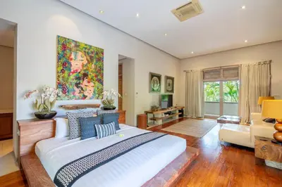 a large bedroom with a large bed and a couch at 4BR Villa with Large Pool at Seminyak Beach in Seminyak