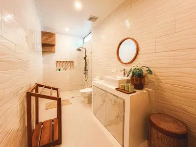 a bathroom with a sink and a toilet and a mirror at Villa Zanetta By Bali Asia Villa in Kerobokan