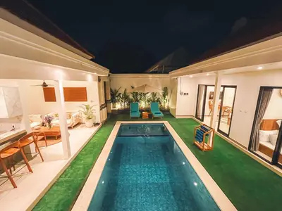 a swimming pool in a villa at night at Villa Zanetta By Bali Asia Villa in Kerobokan
