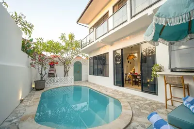 a swimming pool in the backyard of a house at Casa Solace - New! Sparkling villa in the heart of Berawa or Canggu in Canggu