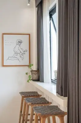 a group of stools sitting next to a window at Casa Solace - New! Sparkling villa in the heart of Berawa or Canggu in Canggu