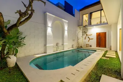 a swimming pool in the backyard of a house at Chic modern villa, 5 minute walk to Legian beach in Legian