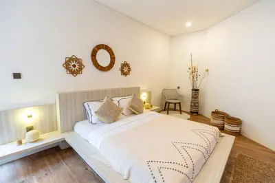 a bedroom with a large white bed in a room at Chic modern villa, 5 minute walk to Legian beach in Legian