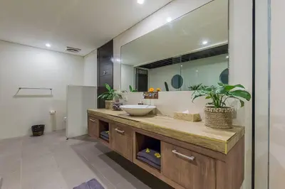 a bathroom with a sink and a mirror at Luxury Hideaway 4 Br Villa 5 minutes to the beach in Seminyak