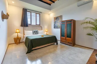 a bedroom with a bed and a window at Villa Wamwui by DreamAwayBali in Seminyak