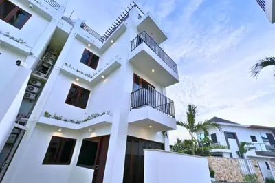 a white building with balconies on it at Cakrawala 3 Bedroom Villa in Jimbaran