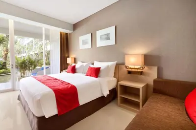 a bedroom with a large bed and a window at Ramada Encore by Wyndham Seminyak Bali in Seminyak