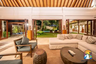 a living room with a couch and a table at Villa Kajou - by Unicorn Villas Bali in Seminyak