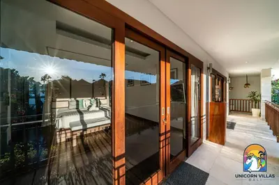a room with glass doors with a view of a bedroom at Villa Kajou - by Unicorn Villas Bali in Seminyak