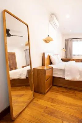 a mirror in a bedroom with a bed at Villa Isla Bali in Seminyak