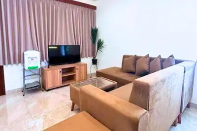 a living room with a couch and a tv at Narendra 1 BR Apartment in Jimbaran
