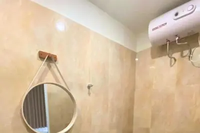 a bathroom with a mirror and a blow dryer at Narendra 1 BR Apartment in Jimbaran