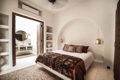 a bedroom with a large bed and a large mirror at Villa Almaz Seminyak in Seminyak