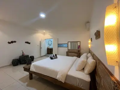 a bedroom with a large bed in a room at Lavender star house in Kuta