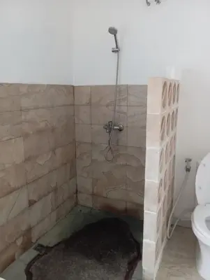 a bathroom with a shower and a toilet at Lavender star house in Kuta