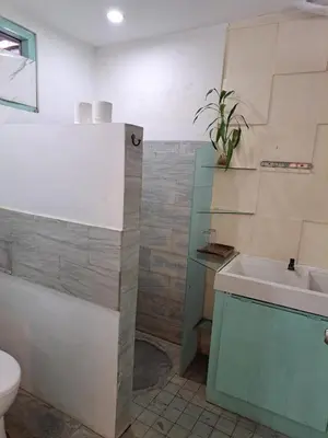 a bathroom with a sink and a tub and a toilet at Lavender star house in Kuta