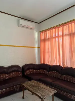 a living room with a couch and a coffee table at Pondok Ledog 02 in Jimbaran