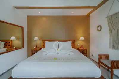 a bedroom with a large white bed and a mirror at Cozy & Private 1 Bed Pool Villa in Trendy Umalas in Kerobokan