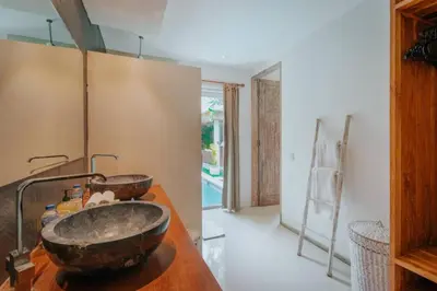 a bathroom with a vessel sink on a wooden counter at Cozy & Private 1 Bed Pool Villa in Trendy Umalas in Kerobokan
