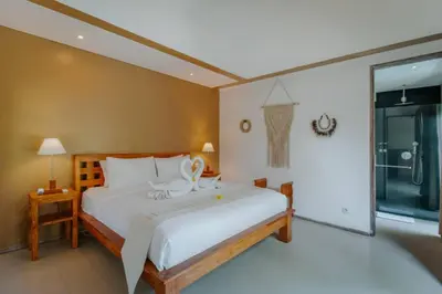 a bedroom with a bed and a large window at Cozy & Private 1 Bed Pool Villa in Trendy Umalas in Kerobokan