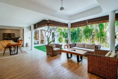 a living room with a couch and a table at Cozy & Private 1 Bed Pool Villa in Trendy Umalas in Kerobokan